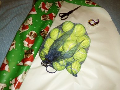 Tennis balls on wrapping paper, waiting to be wrapped.
