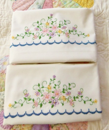 Flowers and scallops embroidered on white pillow case set.