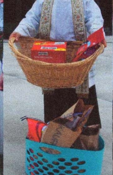 Priest with baskets of donations for local shelter.