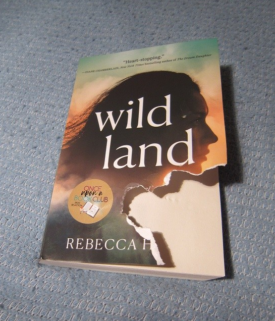 Chewed up cover of the book Wild Land.