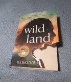 Chewed up cover of the book Wild Land.