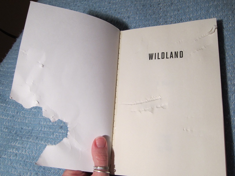 Chewed cover of the book Wild Land.