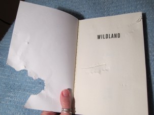 Chewed cover of the book Wild Land.